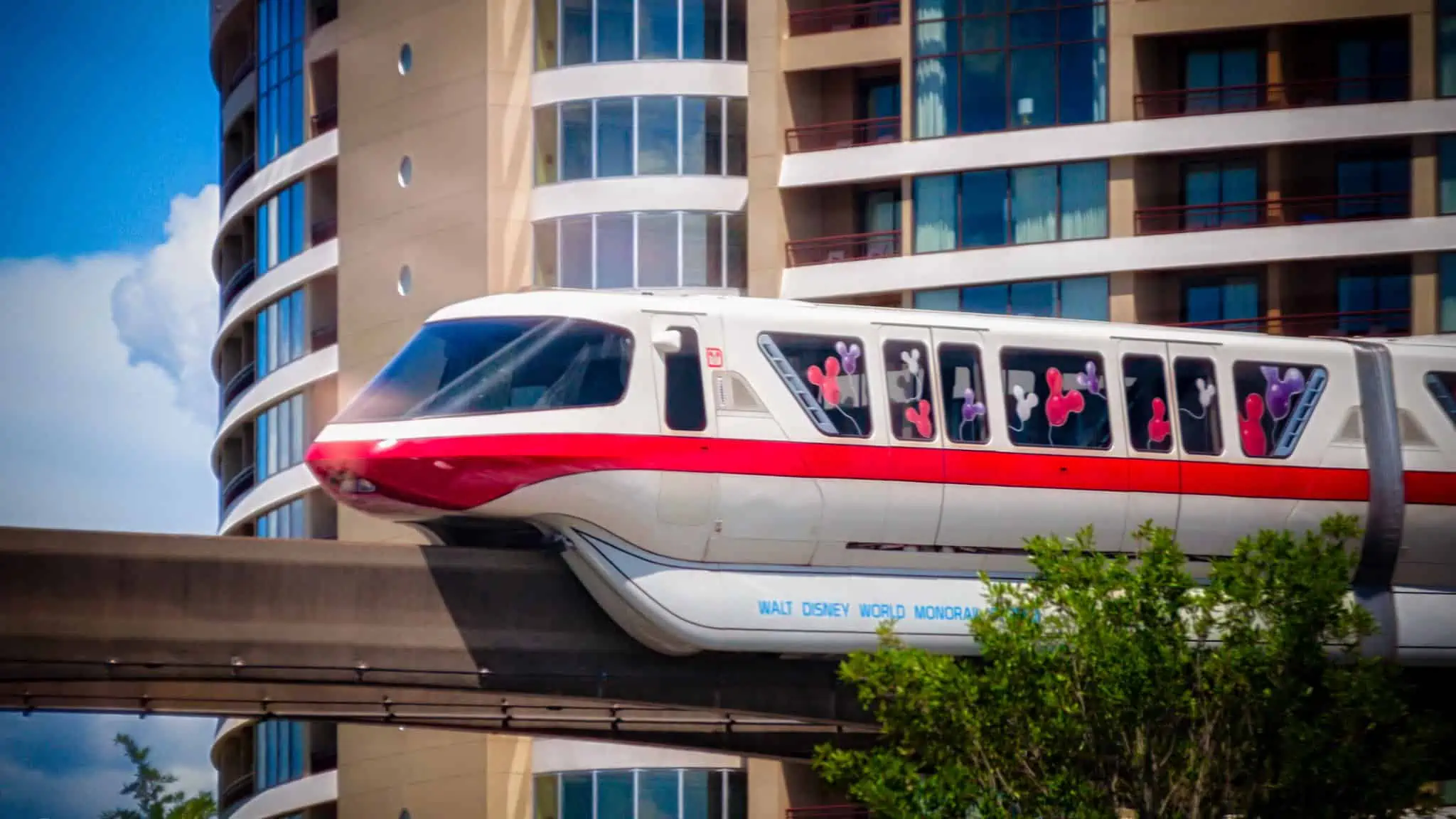 The Disney monorail passing by a resort.